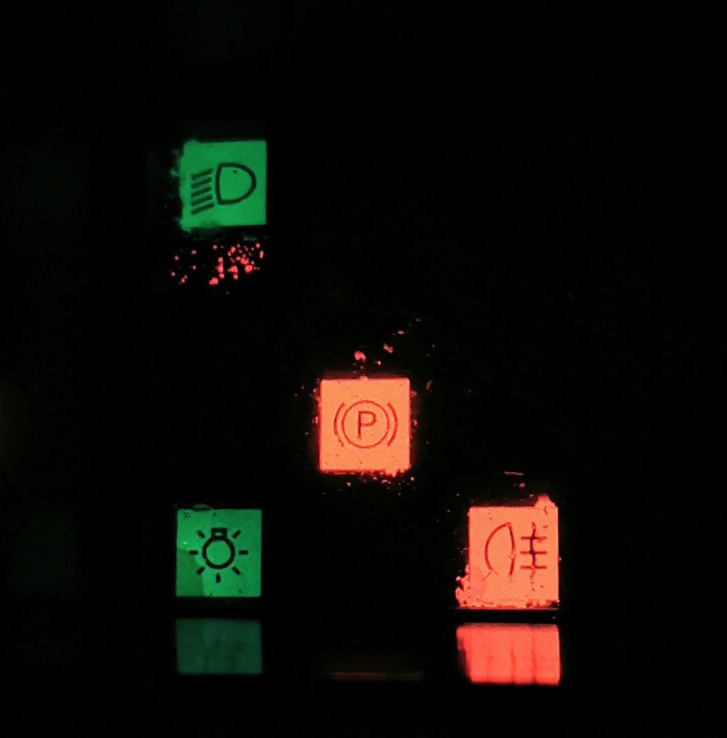 Left hand warning light cluster on the instrument panel of a 1983 Citroen BX14RE showing side light, dipped headlight, parking brake and rear fog light indicators lit