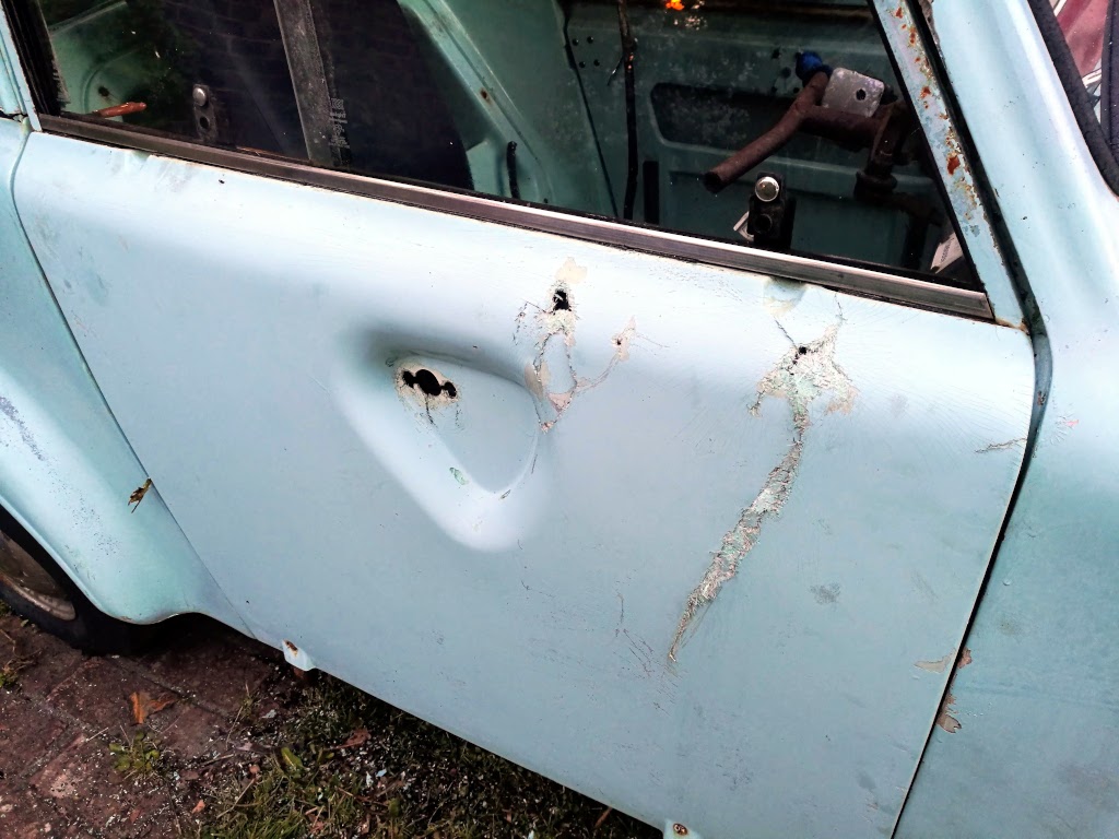 Damage to the offside door skin and handle area