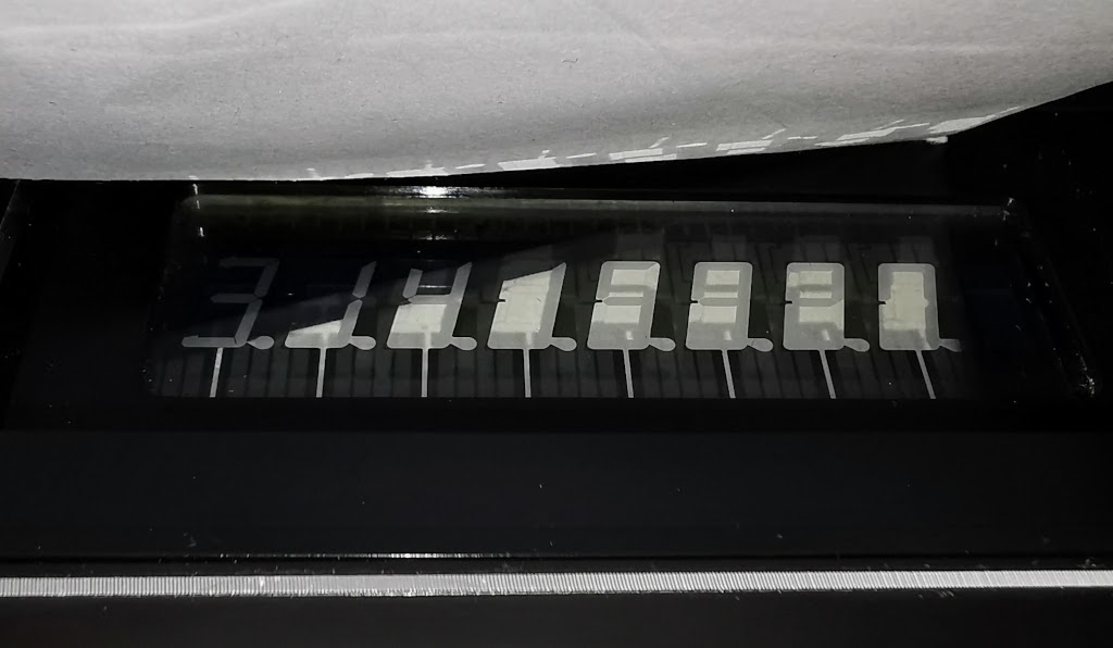 Detail photo showing the reflective backing and frost-like appearance of digits on the DSM display in a Sharp EL-808 Calculator
