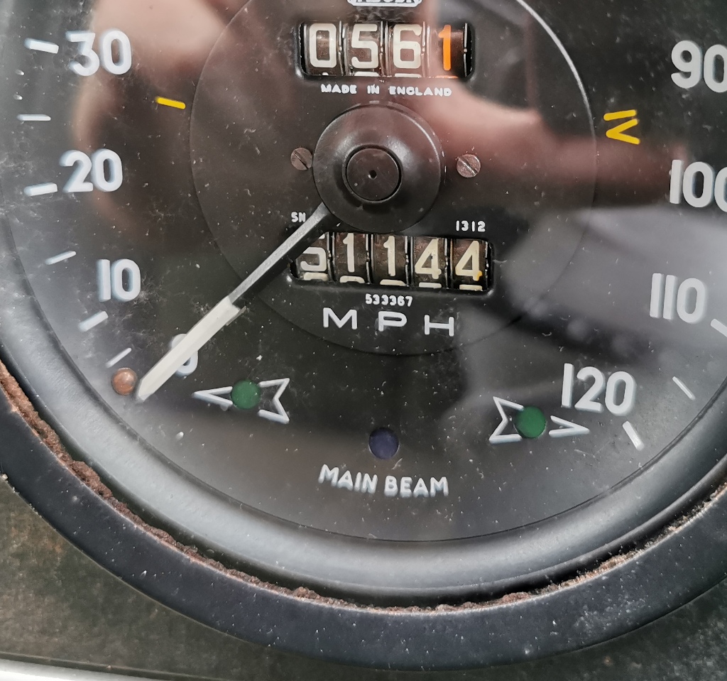 Detail of the indicator/main beam indicator lights on the dash of a 1963 Rover P4 110