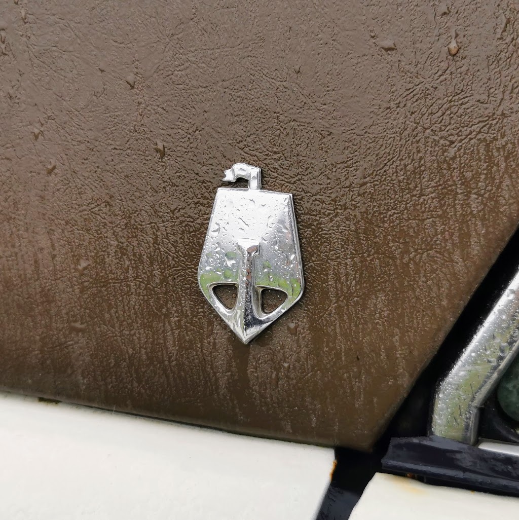 Detail of the stylised version of the Rover Viking Long Ship emblem as seen on the rear C Pillar of a Rover P6