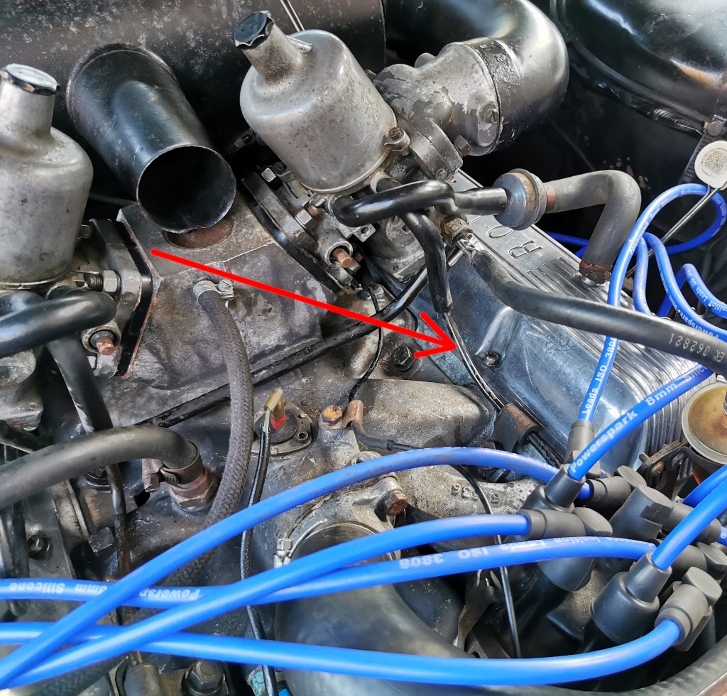Photograph highlighting the left hand carb float bowl vent/overflow line routing on a Rover V8