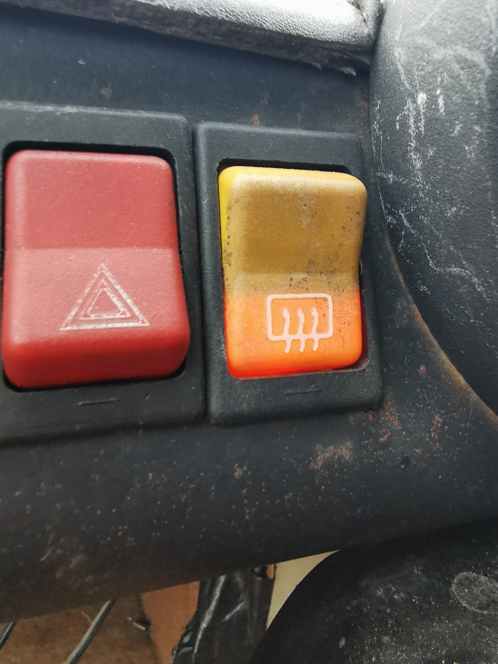 Detail of the heated rear window switch on a 1984 Trabant P601S when illuminated