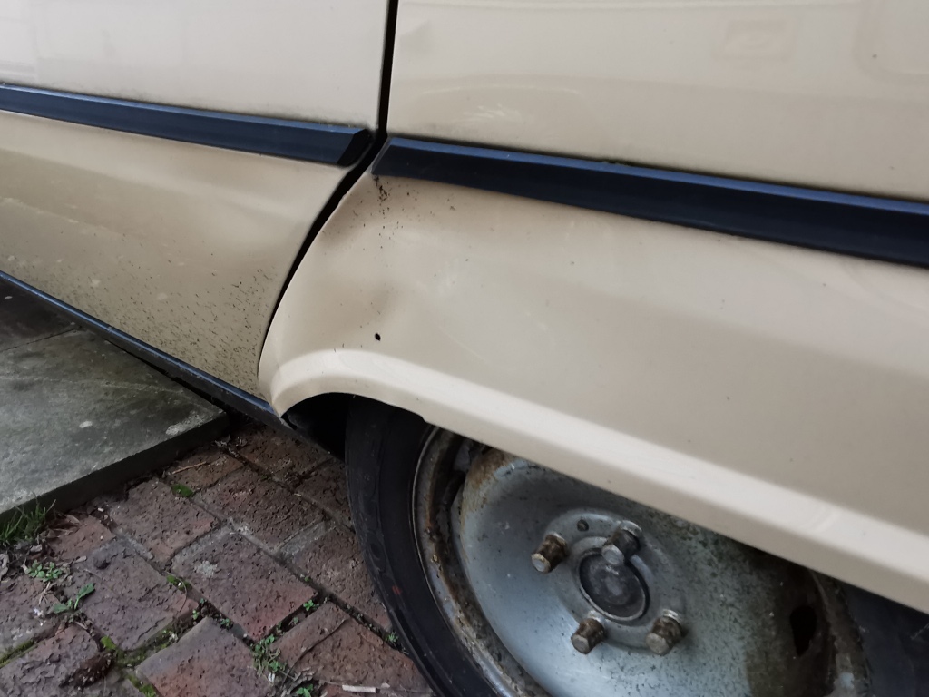 Detail of the dent just forward of the nearside rear wheel