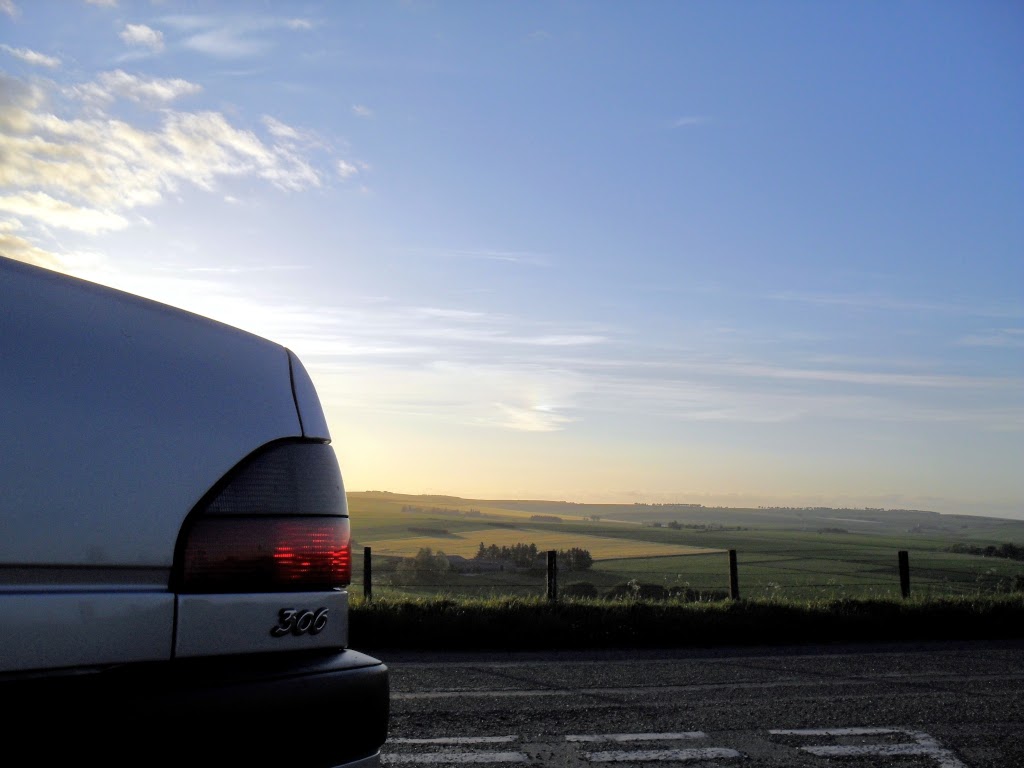 Tail light detail of Peugeot 306 Sedan at sunset