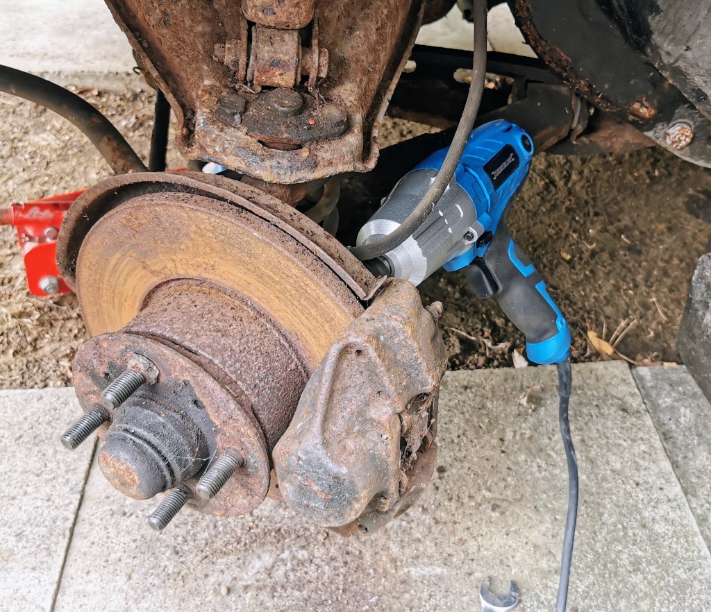 Brake caliper removal in progress