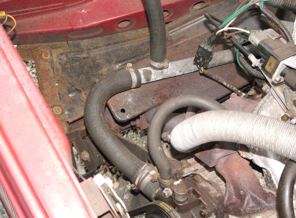 Detail showing the raised step in the splash guard on a Skoda Rapid 135 RiC to accommodate the catalytic converter