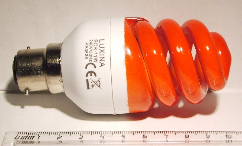 Luxina SCR-11W Orange Coloured Compact Fluorescent Lamp - Shown adjacent to a ruler for scale
