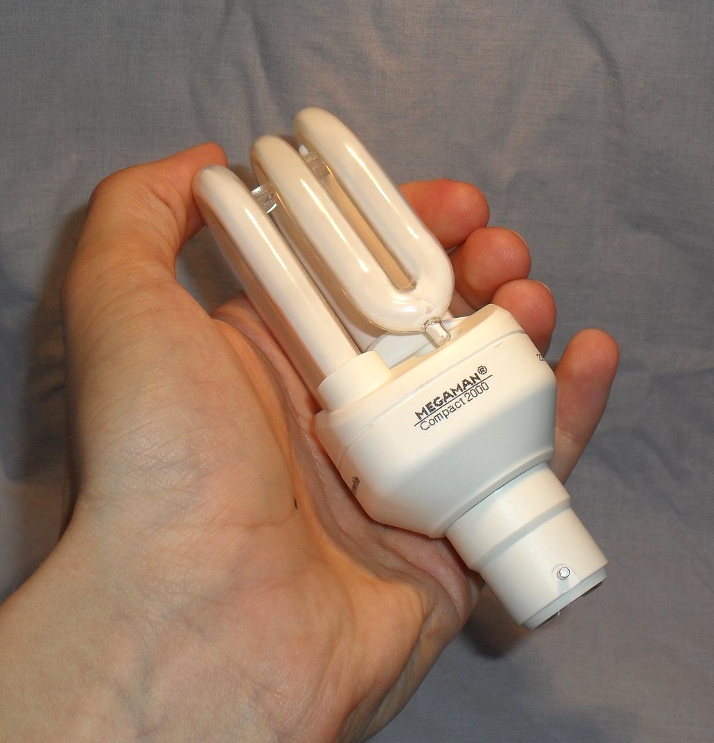 Megaman Compact 2000 11Watt SU111 2700K Warmwhite Compact Fluorescent Lamp shown in hand to give sense of relative scale
