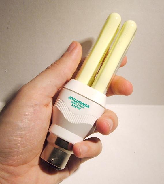 Sylvania Mini-Lynx Pastel 11W Apricot Compact Fluorescent Lamp - Lamp held in hand to give sense of relative scale