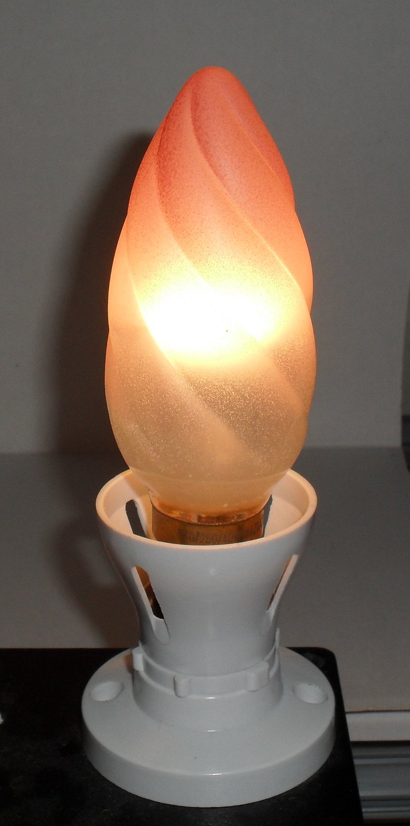 Mazda 40W Pearl Twisted Pink-Tipped Candle Lamp - Lamp shown while alight