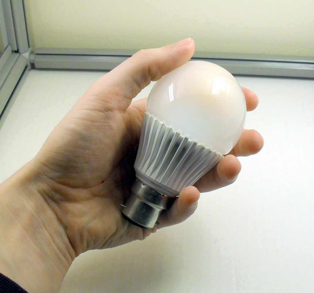 Philips Econic 7W A60 Warm White LED Lamp - Held in hand to show relative scale