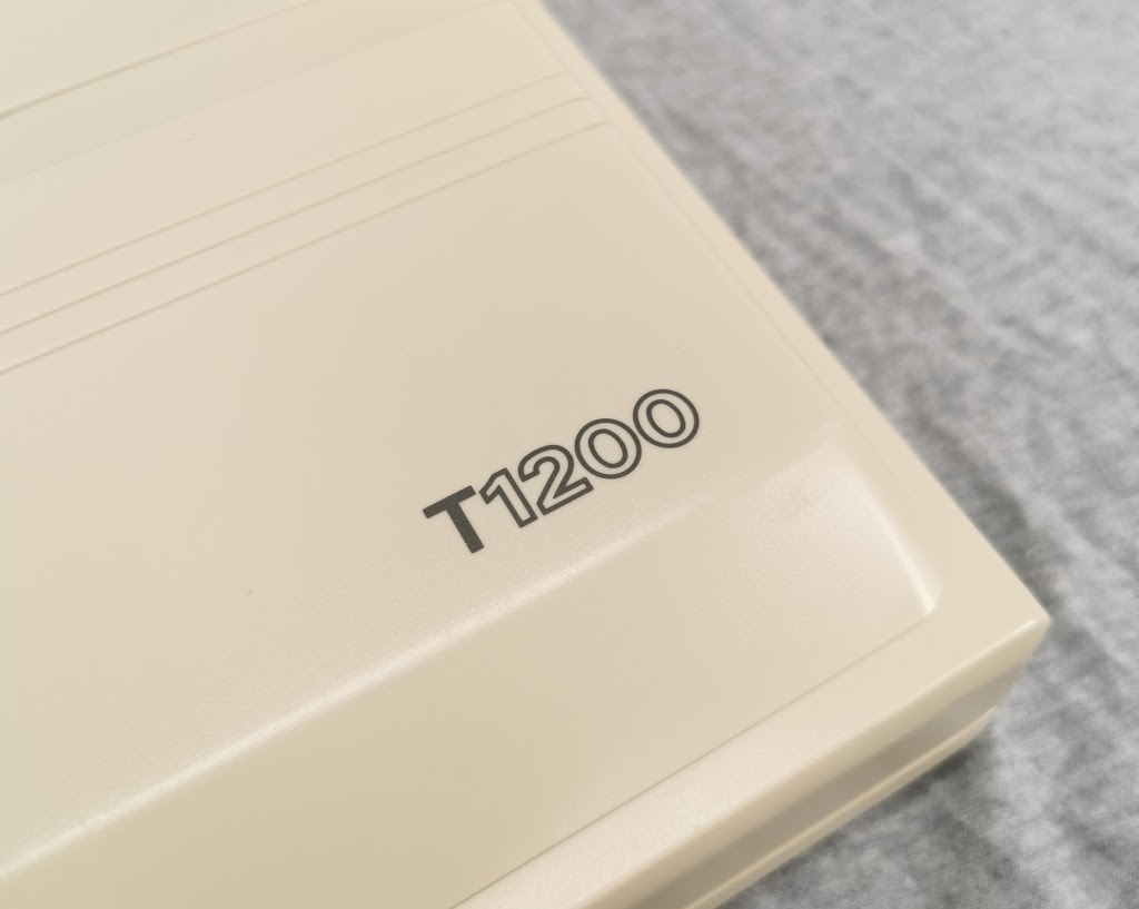 Detail of the model number badging on the back of the display panel of a Toshiba T1200